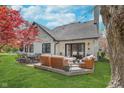 Expansive backyard with patio area, manicured lawn, and classic white home exterior at 333 S 4Th St, Zionsville, IN 46077