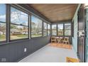 Inviting enclosed front porch with wood ceiling, and plenty of natural light at 3433 Brouse Ave, Indianapolis, IN 46218