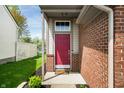 Inviting entryway with a bold red door and brick accents at 376 Lake Ridge Ln, Greenwood, IN 46142