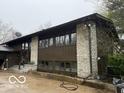 Exterior of house with stone features and a large picture window at 4491 W Stones Crossing Rd, Greenwood, IN 46143
