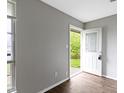 Bright entryway featuring gray walls and hardwood flooring with a clear view to the front yard at 4505 Phoenix Dr, Indianapolis, IN 46241