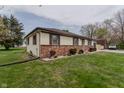 Side view of the ranch home with manicured landscaping and traditional architectural details at 5510 Chelsea Rd, Indianapolis, IN 46241
