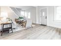 Spacious living room with a staircase, light wood floors, and neutral decor for a cozy atmosphere at 5516 S Randolph St, Indianapolis, IN 46227