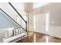 Spacious foyer features hardwood floors, staircase with runner, and front door with sidelights at 559 Hythe Way, Westfield, IN 46074