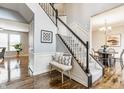 Bright foyer with hardwood floors, stairway with decorative spindles and adjacent dining area at 559 Hythe Way, Westfield, IN 46074