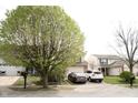 Two-story home with vinyl siding, dark shutters, and an attached two-car garage at 607 Deer Trail Dr, Indianapolis, IN 46217