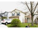 Two-story home with vinyl siding, dark shutters, and an attached two-car garage at 607 Deer Trail Dr, Indianapolis, IN 46217