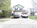 Two-story home with vinyl siding, dark shutters, and an attached two-car garage at 607 Deer Trail Dr, Indianapolis, IN 46217