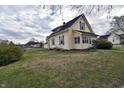 A quaint two-story home featuring a well-manicured lawn and classic architecture at 609 E Columbus St, Martinsville, IN 46151
