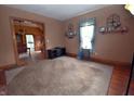 A cozy living room with hardwood floors and neutral carpet, awaiting personal touches at 609 E Columbus St, Martinsville, IN 46151
