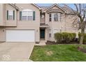 Charming home with an attached two-car garage, bay window, and a well manicured lawn at 6259 Bishops Pond Ln, Indianapolis, IN 46268