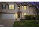 Charming home with an attached two-car garage, bay window, and a well manicured lawn at 6259 Bishops Pond Ln, Indianapolis, IN 46268
