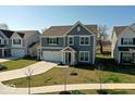 Charming two-story home with gray siding, attached two-car garage, and well-manicured front lawn at 6917 Wheatley Rd, Whitestown, IN 46075
