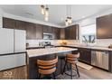 Modern kitchen featuring dark cabinets, stainless steel appliances, granite countertops, and a center island at 6917 Wheatley Rd, Whitestown, IN 46075