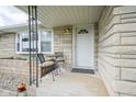 Inviting front porch with seating, creating a cozy entrance to the home at 712 Valley Dr, Anderson, IN 46011