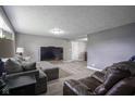 Spacious living room featuring a large TV and comfortable seating arrangements at 712 Valley Dr, Anderson, IN 46011