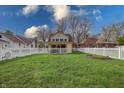 View of an expansive backyard with a white picket fence and a swing set at 720 22Nd St, Columbus, IN 47201
