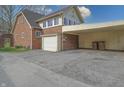 Attached garage and carport showcasing exterior features of the home at 720 22Nd St, Columbus, IN 47201