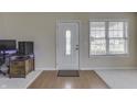 Bright foyer with a white front door with decorative glass, complemented by a neutral color scheme at 7441 Sugar Pine Ct, Avon, IN 46123