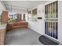 Inviting front porch featuring a cozy porch swing and secure screen door at 87 S 10Th Ave, Beech Grove, IN 46107