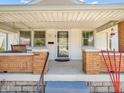 Inviting covered front porch with brick columns and porch swing for relaxing outdoors at 87 S 10Th Ave, Beech Grove, IN 46107