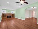 Spacious living room featuring a fireplace with brick surround, hardwood floors, and an arched doorway at 87 S 10Th Ave, Beech Grove, IN 46107