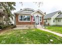 Inviting home with brick accents, a manicured lawn, and a pathway to the front entrance at 905 E Yoke St, Indianapolis, IN 46203