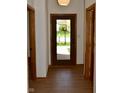 Entryway hallway featuring wood floors, neutral walls, and a view of the front door at 12731 Slippery Rock Rd, Indianapolis, IN 46236