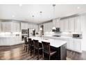 Spacious kitchen with stainless steel appliances, large island with seating, and ample counter space at 12959 Girvan Way, Fishers, IN 46037