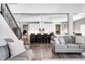 Comfortable living room with views of eat in kitchen featuring a large center island with pendant lighting at 12959 Girvan Way, Fishers, IN 46037