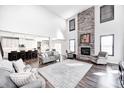 Bright living room with stone fireplace, cathedral ceilings, and lots of comfortable seating at 12959 Girvan Way, Fishers, IN 46037