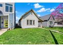 Traditional home boasting a well-manicured lawn and charming curb appeal under a sunny sky at 1422 Olive St, Indianapolis, IN 46203