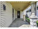 Inviting covered front porch showcasing decorative pillars, offering a cozy entry to the home at 1422 Olive St, Indianapolis, IN 46203