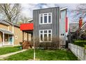 Striking modern home with gray siding, red accents, and lush green lawn at 1430 Fletcher Ave, Indianapolis, IN 46203