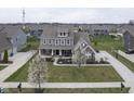 A beautiful home showcasing professional landscaping and a basketball court at 15594 Garrano Ln, Fishers, IN 46040