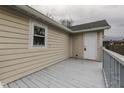 An elevated view shows the spacious deck attached to this beige home with white trim at 1623 N Centennial St, Indianapolis, IN 46222