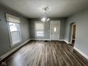 Bright living room features refinished hardwood floors, fresh paint, and great natural light at 1626 S State Ave, Indianapolis, IN 46203