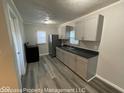 Well-lit kitchen featuring stainless steel appliances, sleek gray cabinetry, and modern countertops at 1708 W 7Th St, Muncie, IN 47302
