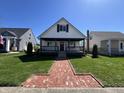 Inviting two-story home with a cozy front porch, brick walkway, and well-maintained lawn at 2029 Winton Ave, Indianapolis, IN 46224