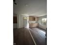 Kitchen area featuring wood-look flooring, cabinets, a white door and window, ready for finishing touches at 2157 S Meridian St, Indianapolis, IN 46225