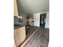 Unfinished kitchen features wood-look flooring, natural wood cabinets, and a window, awaiting completion at 2157 S Meridian St, Indianapolis, IN 46225