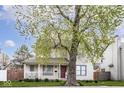 Charming two-story home with a well-maintained front yard and inviting red front door at 2615 N Delaware St, Indianapolis, IN 46205