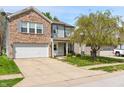 Attractive two-story home featuring a mix of brick and siding, complemented by a well-kept lawn and a two-car garage at 350 Springfield Cir, Greenwood, IN 46143