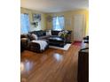 Inviting living room featuring a large sectional sofa and warm wood flooring at 350 Springfield Cir, Greenwood, IN 46143