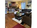 Comfortable living room with a stone fireplace, wood floors, and a plush sofa at 350 Springfield Cir, Greenwood, IN 46143