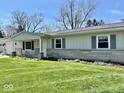 Charming single-story home with tidy landscaping and a stone accent along the front of the house at 3601 N Oakwood Ave, Muncie, IN 47304