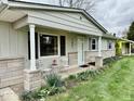 Cozy front porch area featuring two chairs and landscaping at 3601 N Oakwood Ave, Muncie, IN 47304