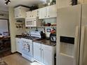 Functional kitchen featuring white cabinetry, essential appliances, and a bright, clean ambiance at 3614 Thorncrest Dr, Indianapolis, IN 46234