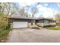 Lovely ranch home with an attached garage and a well-manicured lawn at 3636 E 71St St, Indianapolis, IN 46220