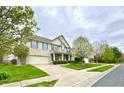 Charming two-story brick home with blue shutters, a covered porch, well-kept lawn, and attached garage at 3724 Jonathan Rdg, Columbus, IN 47201